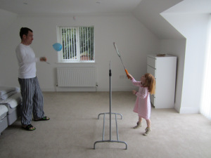 Far og Cille øver badminton og tennis på gæsteværelset